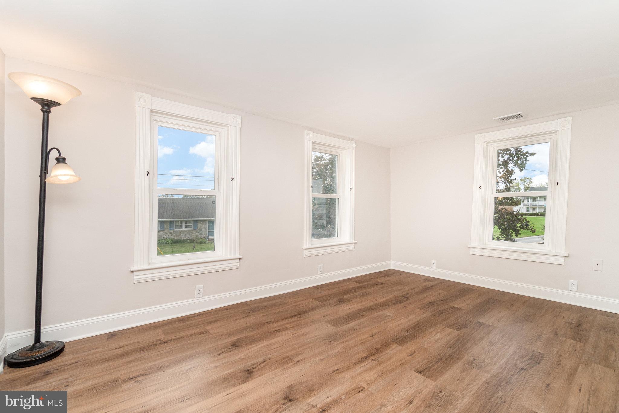 1103 Graystone Road Manheim, PA 17545 - Photo 15 of 24 an empty room with wooden floor and windows