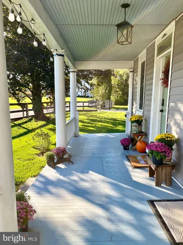 a view of a porch with dining table and chairs