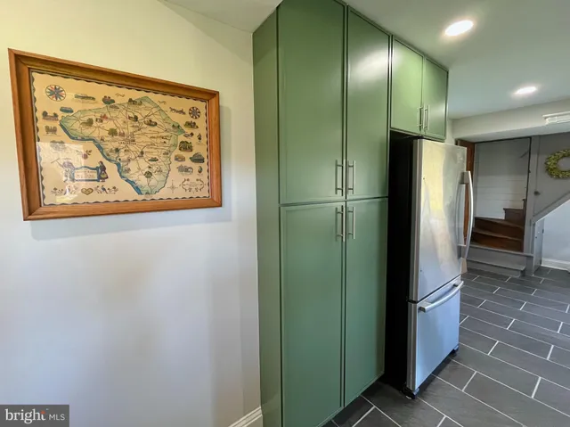 a bathroom with a sink a mirror and painting on the wall