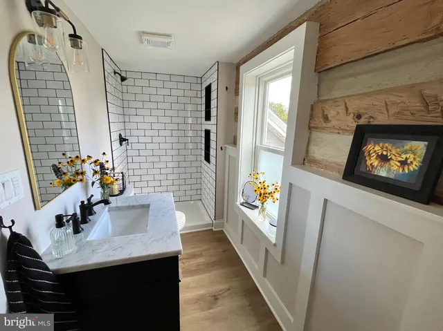 a bathroom with a sink mirror vanity and toilet