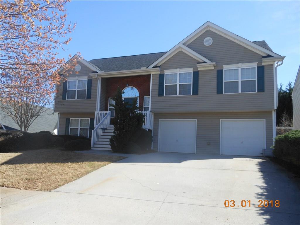 244 Berkley Drive Villa Rica, GA 30180 - Photo 1 of 1 a front view of a house with a yard and garage