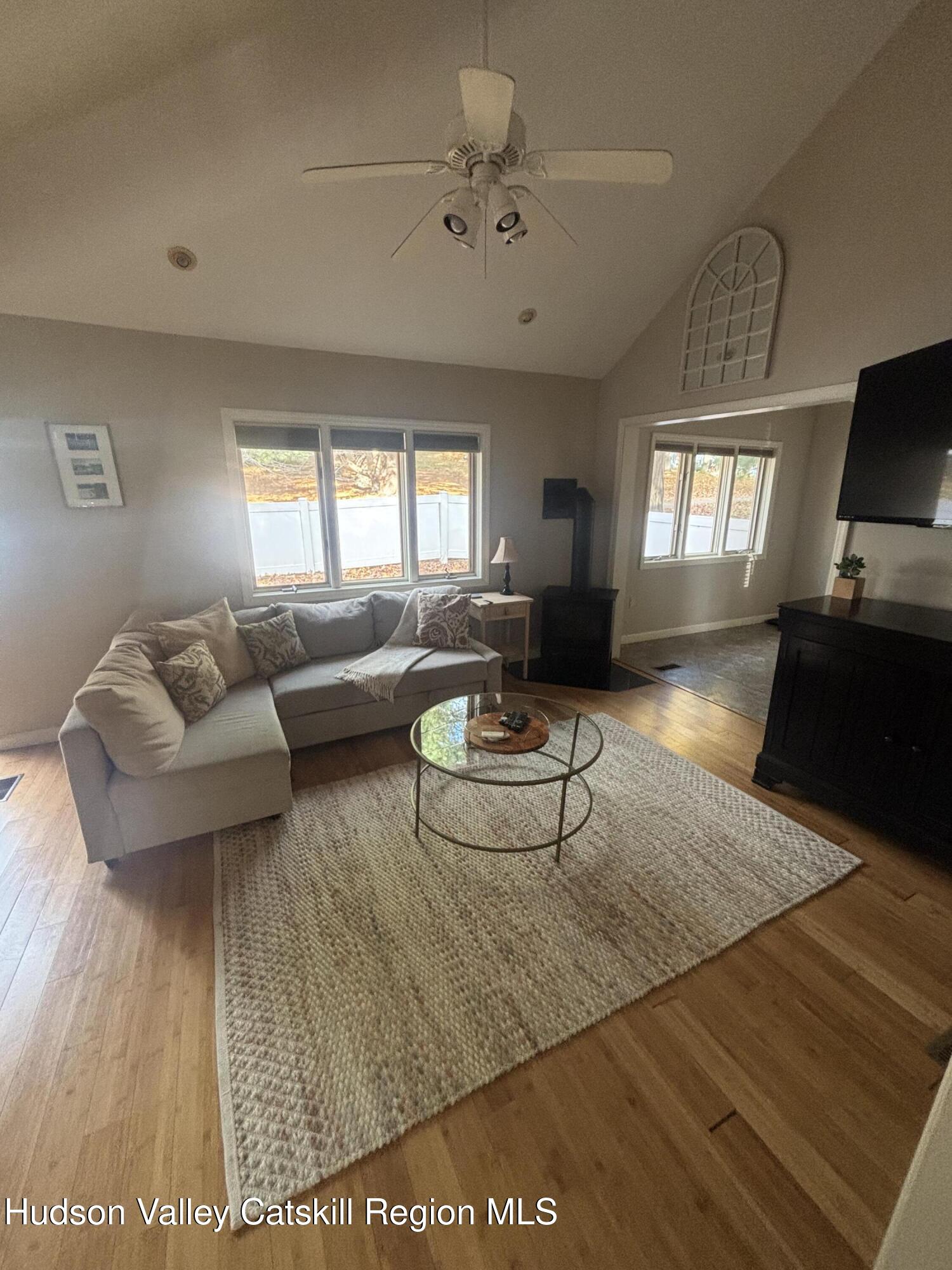 419 Southwest Colony Road Hillsdale, NY 12529 - Photo 3 of 10 a living room with furniture and a flat screen tv
