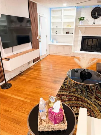 a living room with a fireplace and a flat screen tv