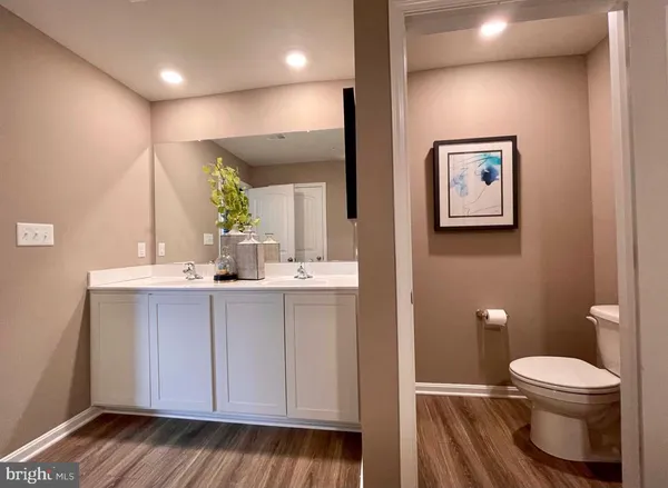 a bathroom with a toilet sink and mirror