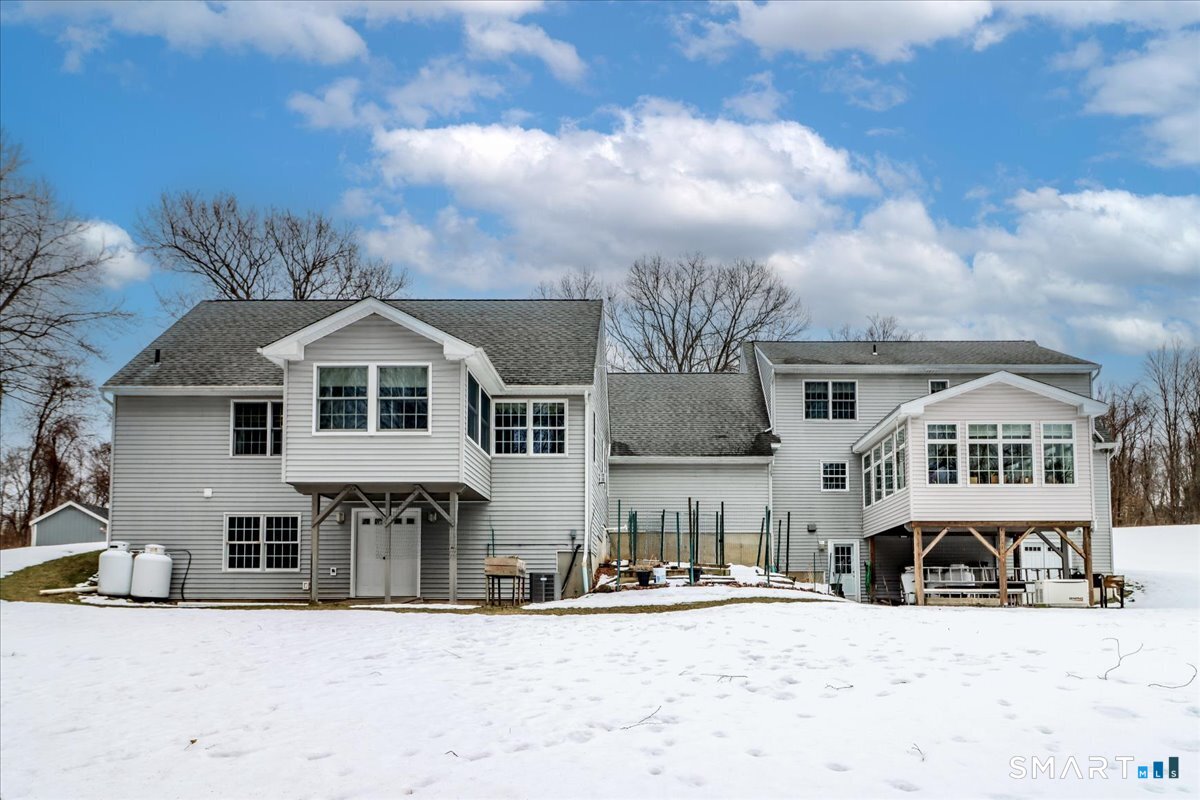 55 Washington Ridge Road New Milford, CT 06776 - Photo 12 of 40 a front view of a house with a yard covered in snow