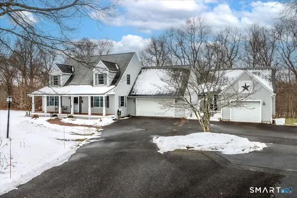 a view of a house with snow on the road