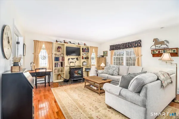 a living room with furniture a table and a large window