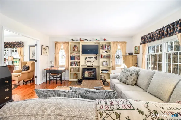 a view of a dining room with furniture and wooden floor