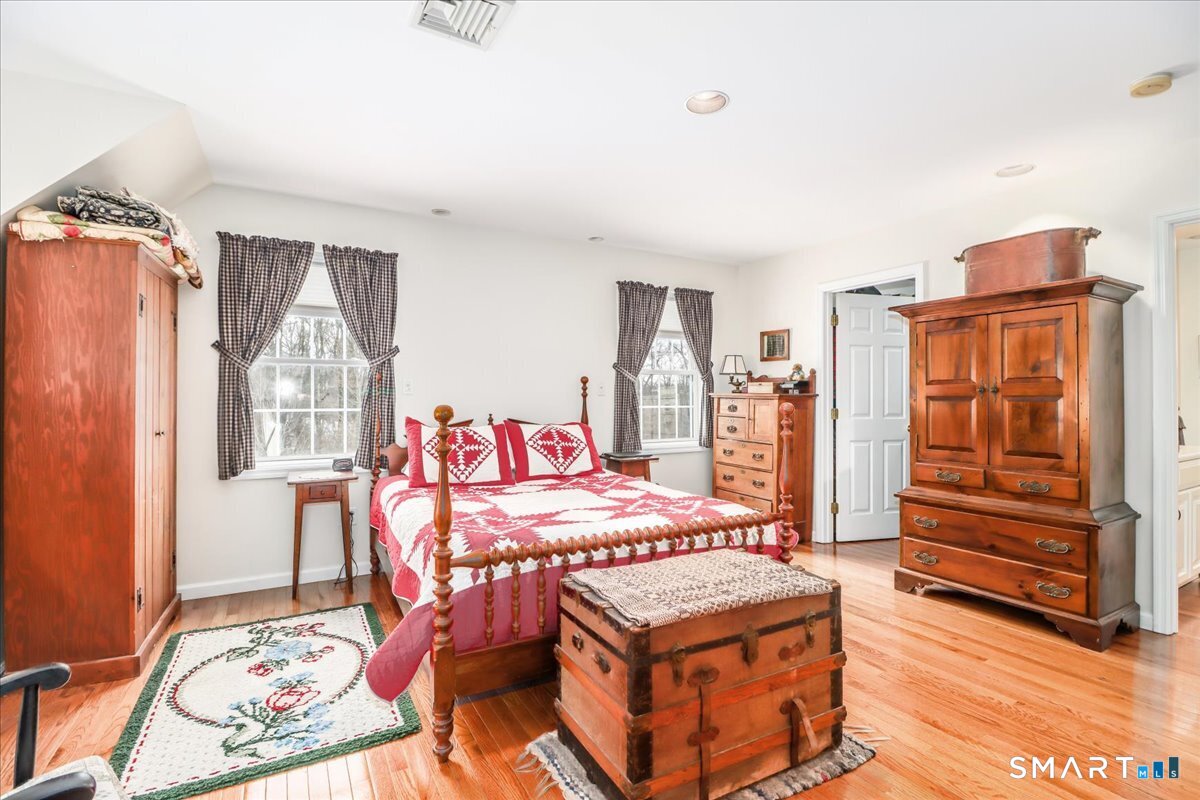 55 Washington Ridge Road New Milford, CT 06776 - Photo 29 of 40 a bedroom with a bed and wooden floor