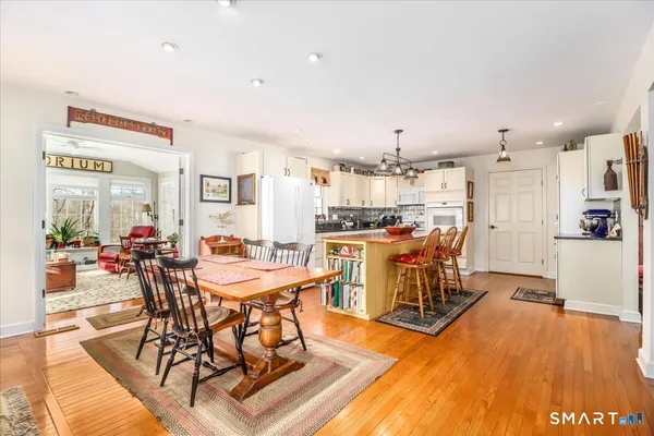 a view of a dining room with furniture and wooden floor