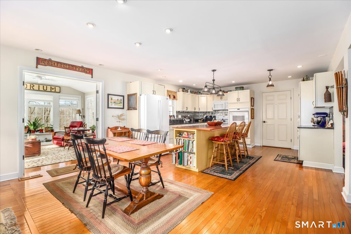 55 Washington Ridge Road New Milford, CT 06776 - Photo 3 of 40 a view of a dining room with furniture and wooden floor