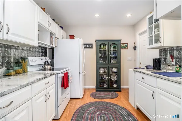 a front view of a house with a yard covered in snow