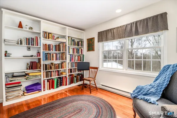 a bedroom with a bed a table and chair