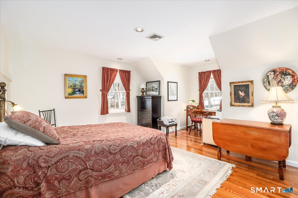 55 Washington Ridge Road New Milford, CT 06776 - Photo 7 of 40 a bedroom with a bed a table and chair