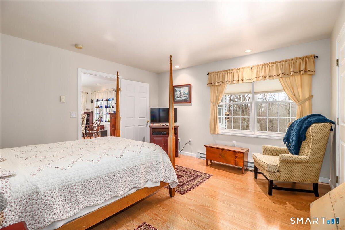 55 Washington Ridge Road New Milford, CT 06776 - Photo 9 of 40 a bedroom with a bed chair and a large window