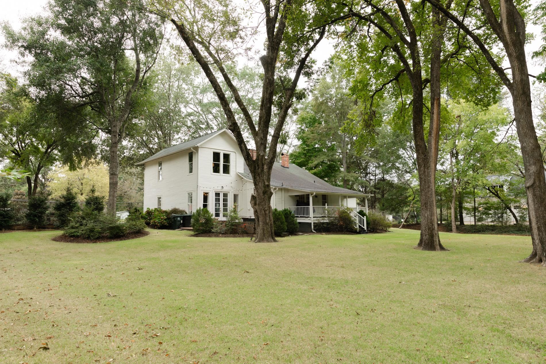232 West Poplar Avenue Collierville, TN 38017 - Photo 35 of 36 View of grassy yard with view of scattered trees and a porch