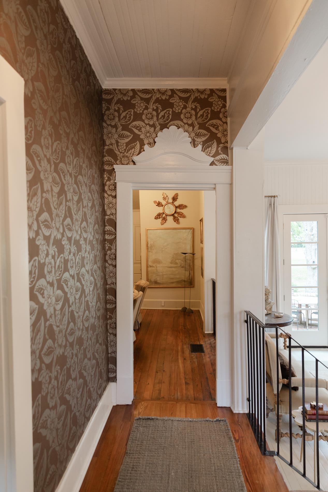 232 West Poplar Avenue Collierville, TN 38017 - Photo 4 of 36 Hallway with wood-type flooring, wallpapered walls, and ornamental molding