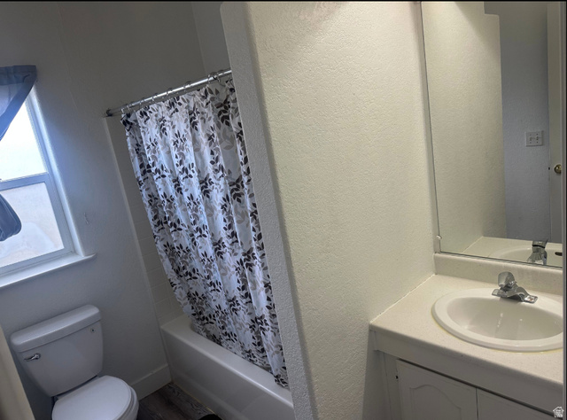 265 Mindella Way Layton, UT 84041 - Photo 19 of 32 Bathroom featuring a tub/shower combination, white toilet, and a vanity with an integrated sink and mirror