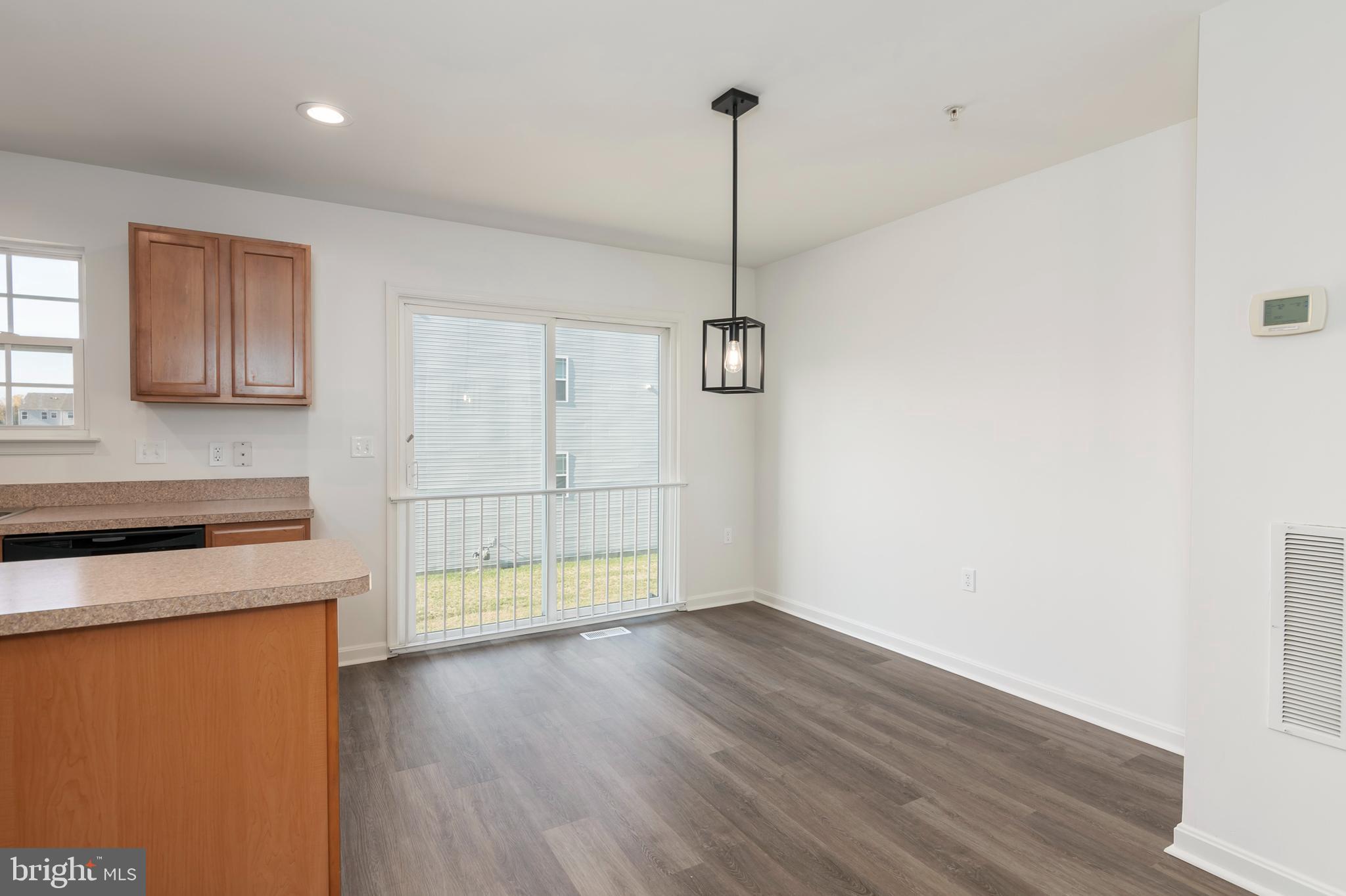 1533 Global Circle Cambridge, MD 21613 - Photo 12 of 27 a view of an empty room with wooden floor and a window