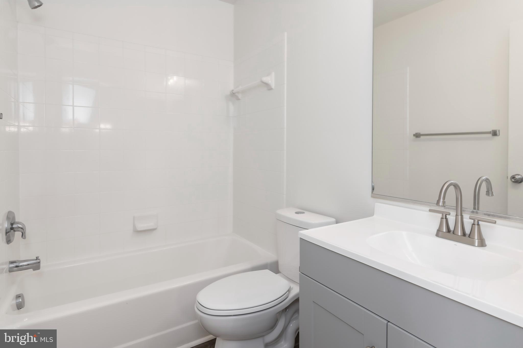 1533 Global Circle Cambridge, MD 21613 - Photo 20 of 27 a bathroom with a sink a toilet and shower