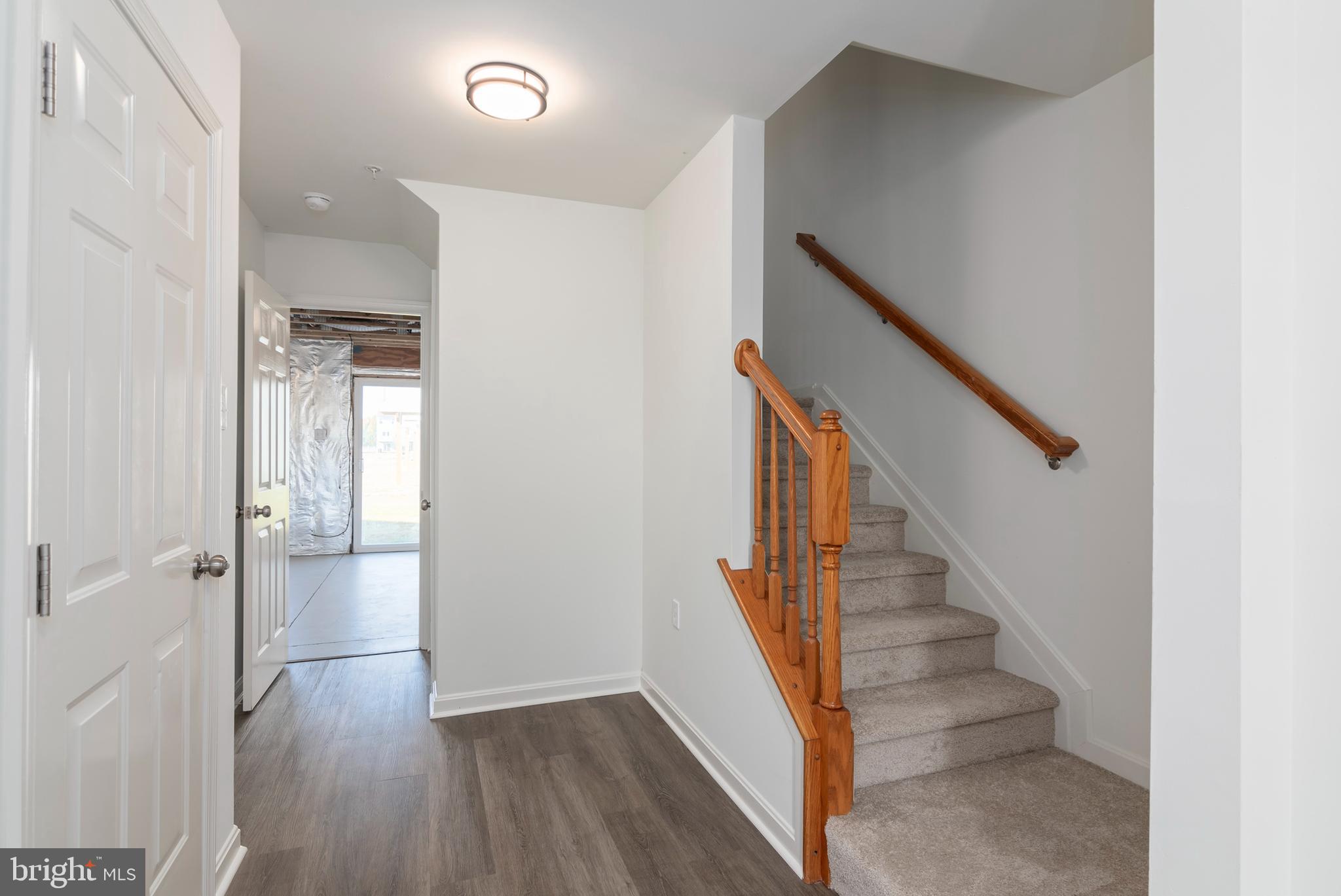 1533 Global Circle Cambridge, MD 21613 - Photo 9 of 27 a view of a hallway with wooden floor and entryway