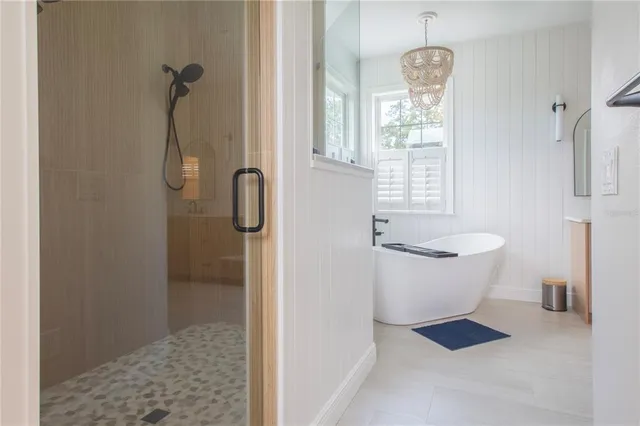 a view of backyard with a white house and wooden fence