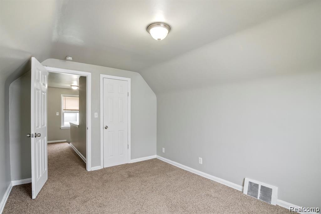 285 Campbell Street River Rouge, MI 48218 - Photo 18 of 33 Bonus room with lofted ceiling and light colored carpet