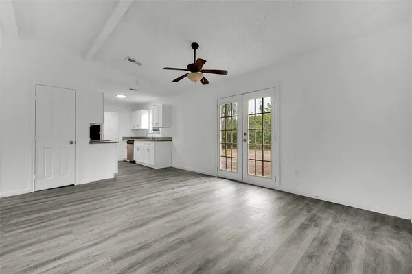 a view of a kitchen with wooden floor and a kitchen