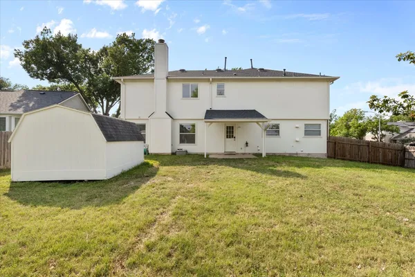 a view of a house with a backyard
