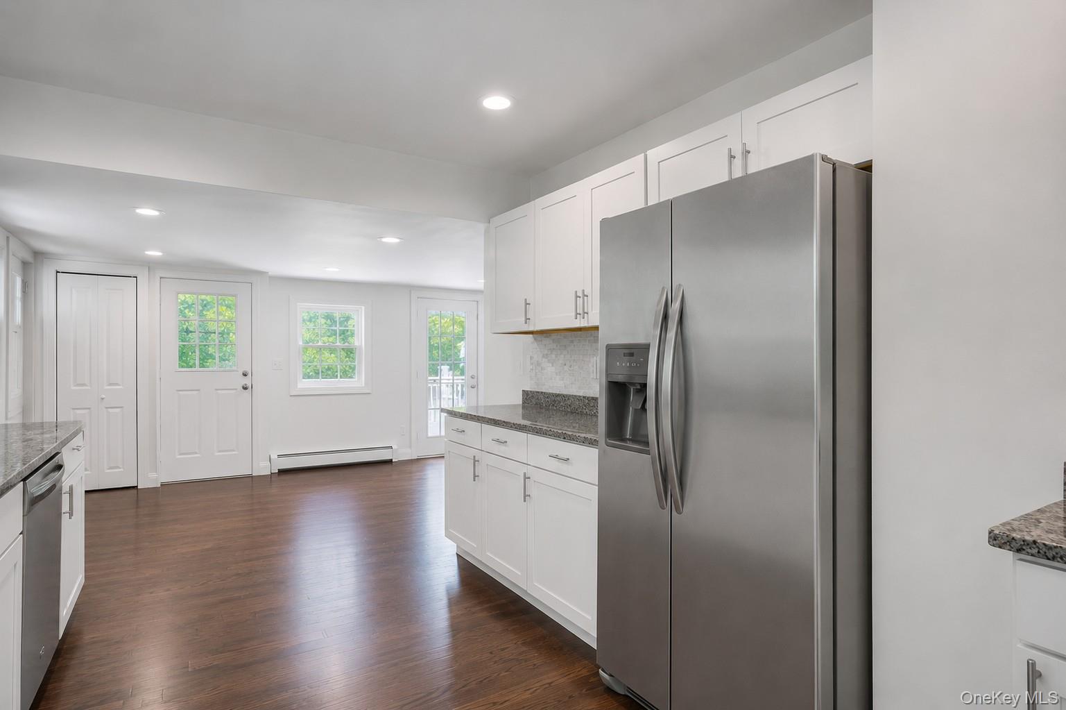 2374 Bruynswick Road Wallkill, NY 12589 - Photo 10 of 35 Kitchen featuring white cabinetry, stainless steel appliances, granite-style countertops, wood-finish flooring, and recessed lighting