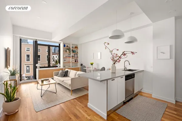 a living room with furniture a large window and potted plants