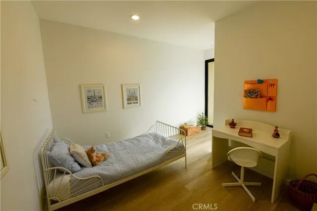 a view of hallway with wooden floor and furniture