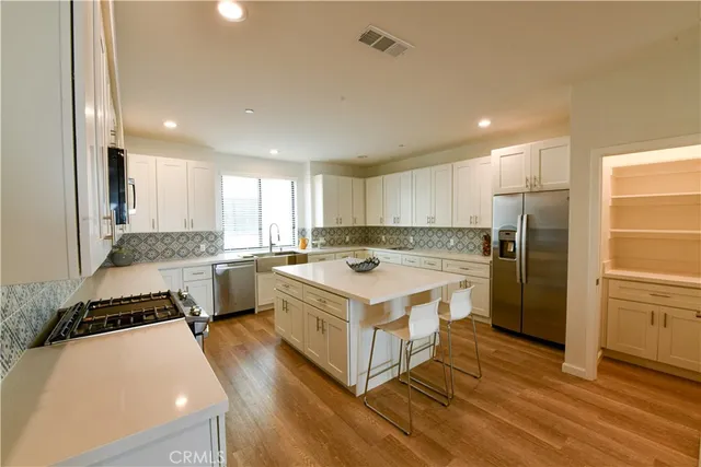 a kitchen with lots of counter top space and stainless steel appliances