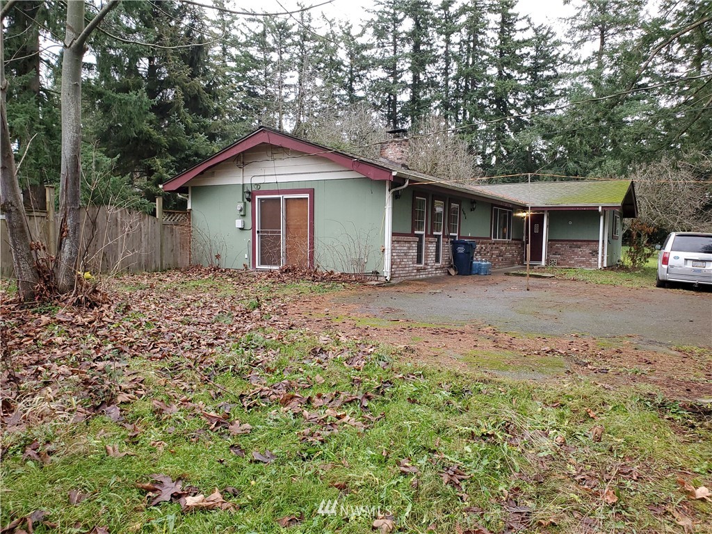 6076 Fazon Road Bellingham, WA 98226 - Photo 18 of 19 a view of a house with a yard and large trees