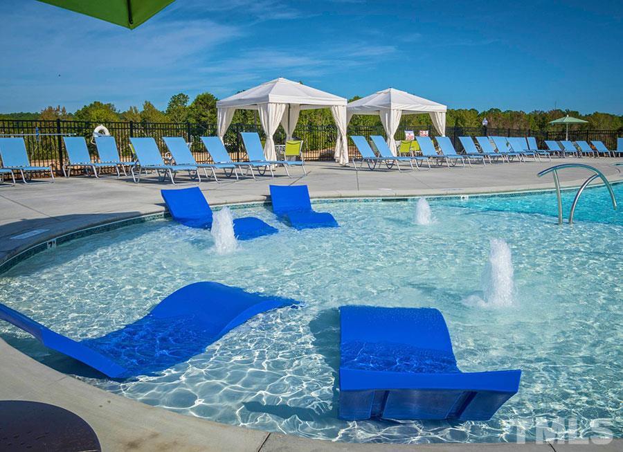 925 Wildflower Ridge Road Wake Forest, NC 27587 - Photo 22 of 24 a view of an chairs and table in the patio