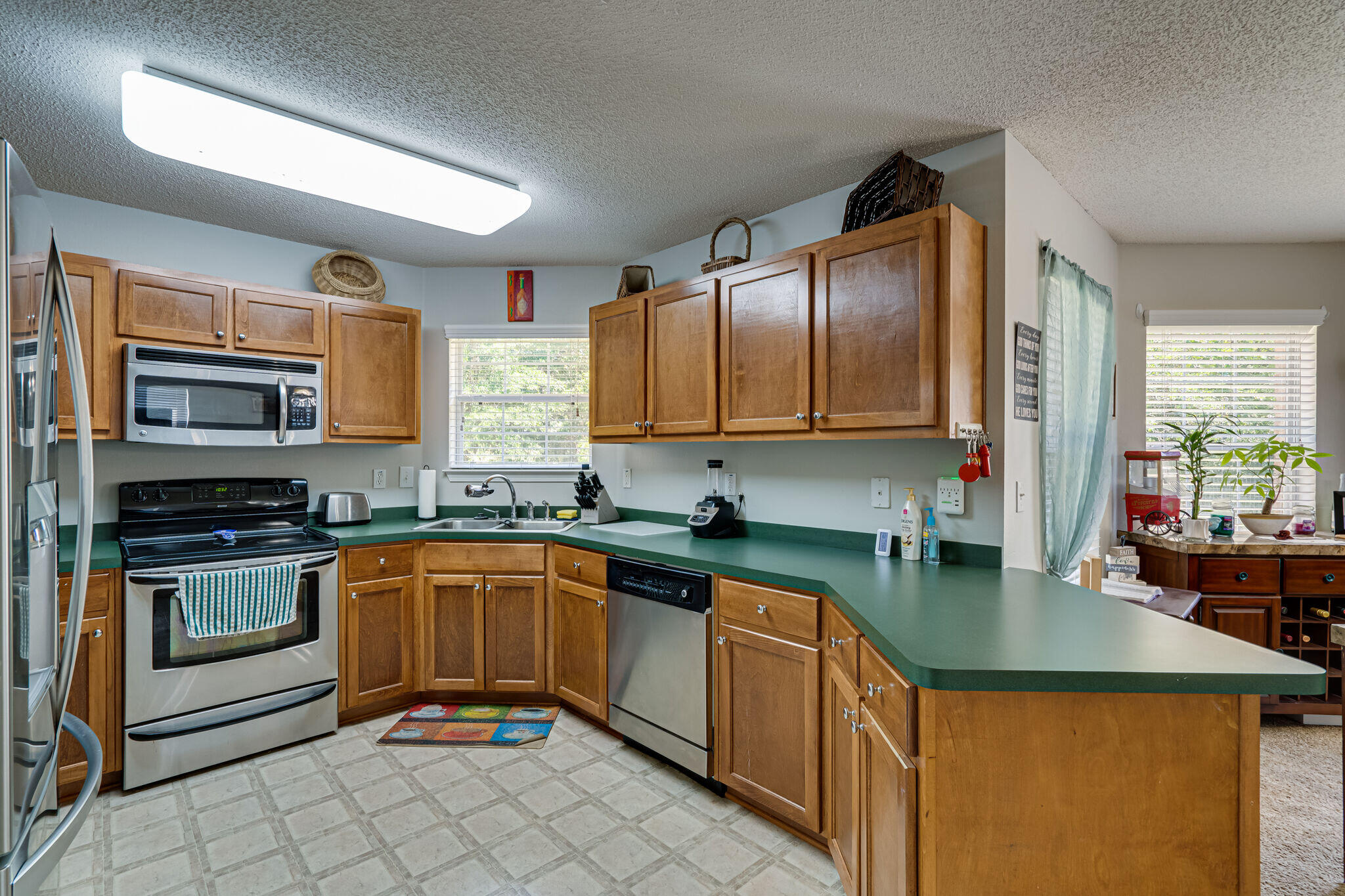 412 Plate Drive Crestview, FL 32539 - Photo 12 of 29 a kitchen with stainless steel appliances granite countertop a sink stove and refrigerator