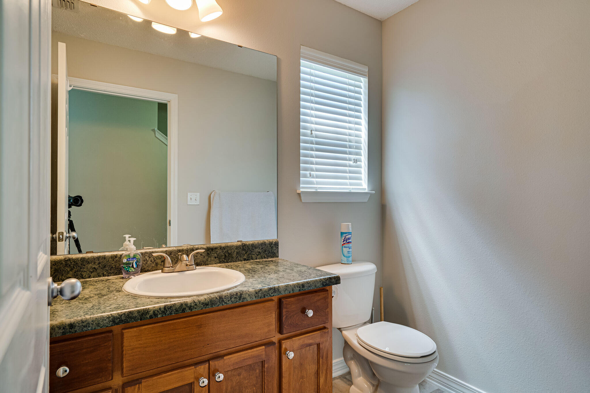 412 Plate Drive Crestview, FL 32539 - Photo 15 of 29 a bathroom with a granite countertop sink toilet and mirror