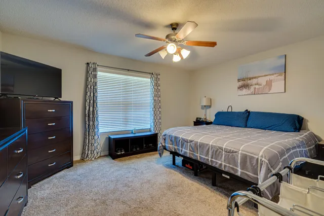 a bedroom with a bed and a tv