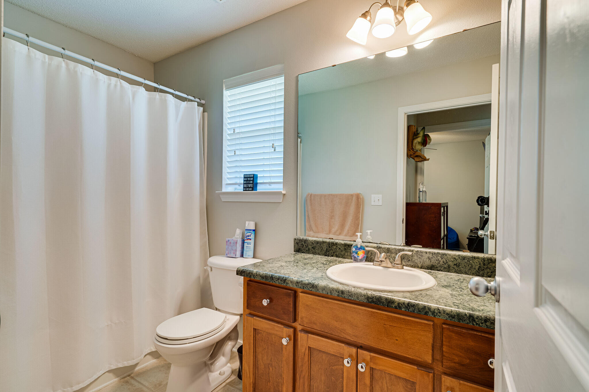 412 Plate Drive Crestview, FL 32539 - Photo 23 of 29 a bathroom with a granite countertop sink toilet and mirror