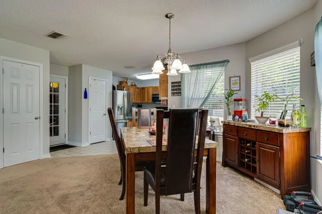 a view of a dining room and livingroom with furniture window and wooden floor