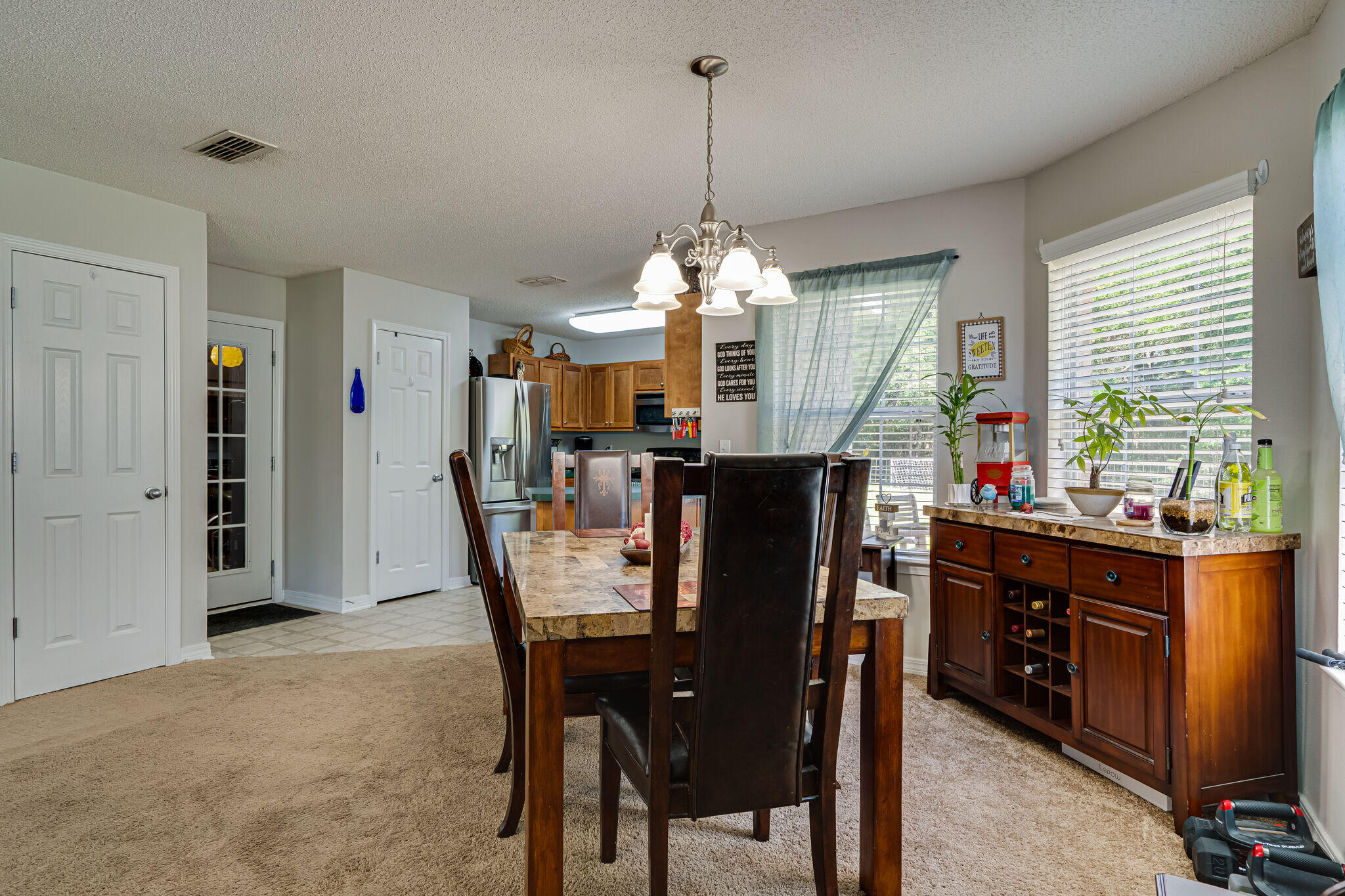 412 Plate Drive Crestview, FL 32539 - Photo 8 of 29 a view of a dining room and livingroom with furniture window and wooden floor
