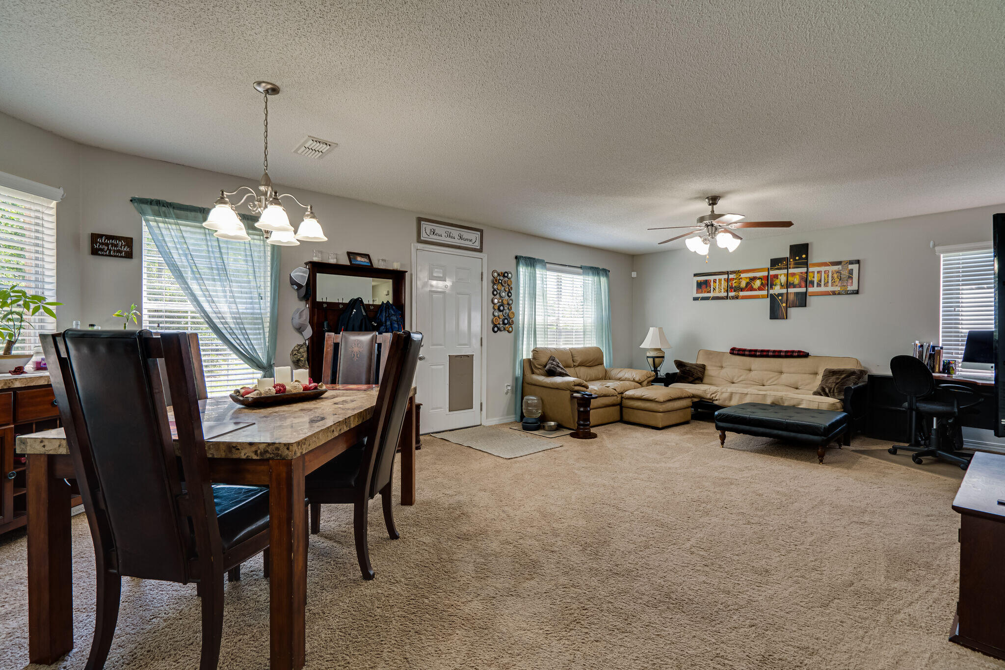 412 Plate Drive Crestview, FL 32539 - Photo 9 of 29 a living room with furniture and a chandelier