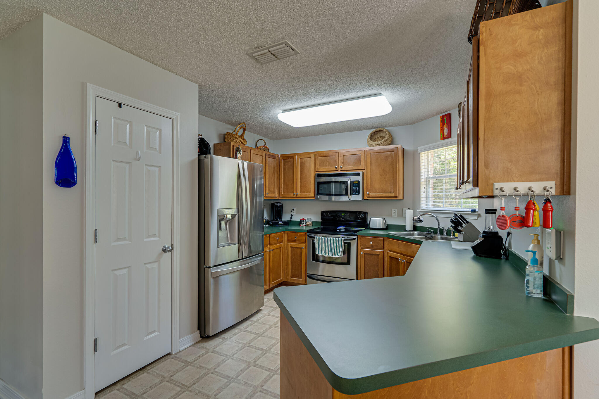 412 Plate Drive Crestview, FL 32539 - Photo 10 of 29 a kitchen with stainless steel appliances granite countertop a refrigerator a stove and a sink