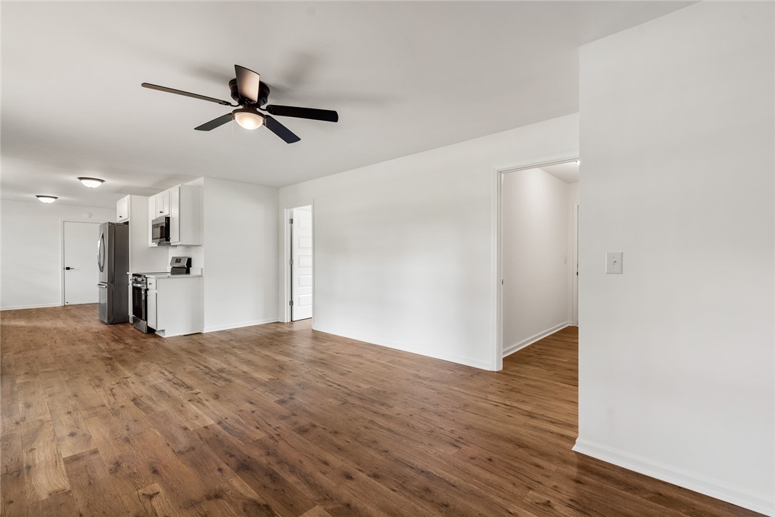 300 Vandiver Road Anderson, SC 29621 - Photo 6 of 30 Rich hardwood floors unite the open-concept living space and a compact, functional kitchen.