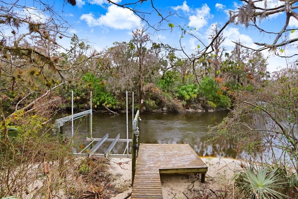 4872 Rambling River Road Brandon, FL 33511 - Photo 2 of 29 a wooden deck with lake view