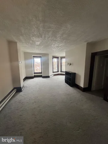 a view of a kitchen with a sink dishwasher oven window and wooden floor