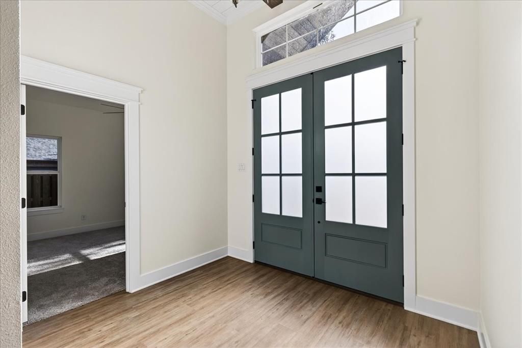 114 Castlewood Road Enchanted Oaks, TX 75156 - Photo 6 of 33 a view of an empty room with wooden floor and a window