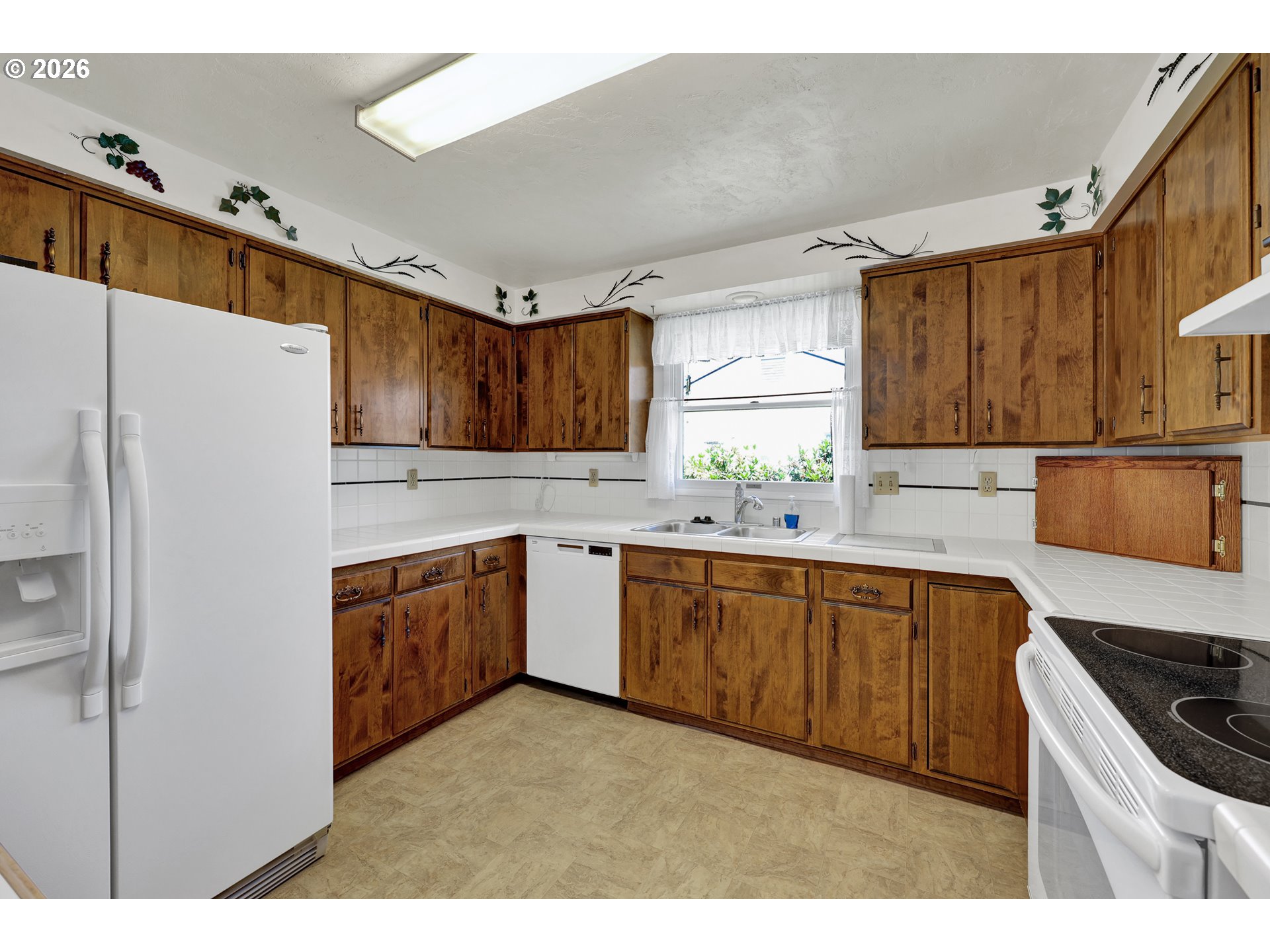 1425 Taney Street Eugene, OR 97402 - Photo 12 of 34 a kitchen with granite countertop a refrigerator stove top oven and sink