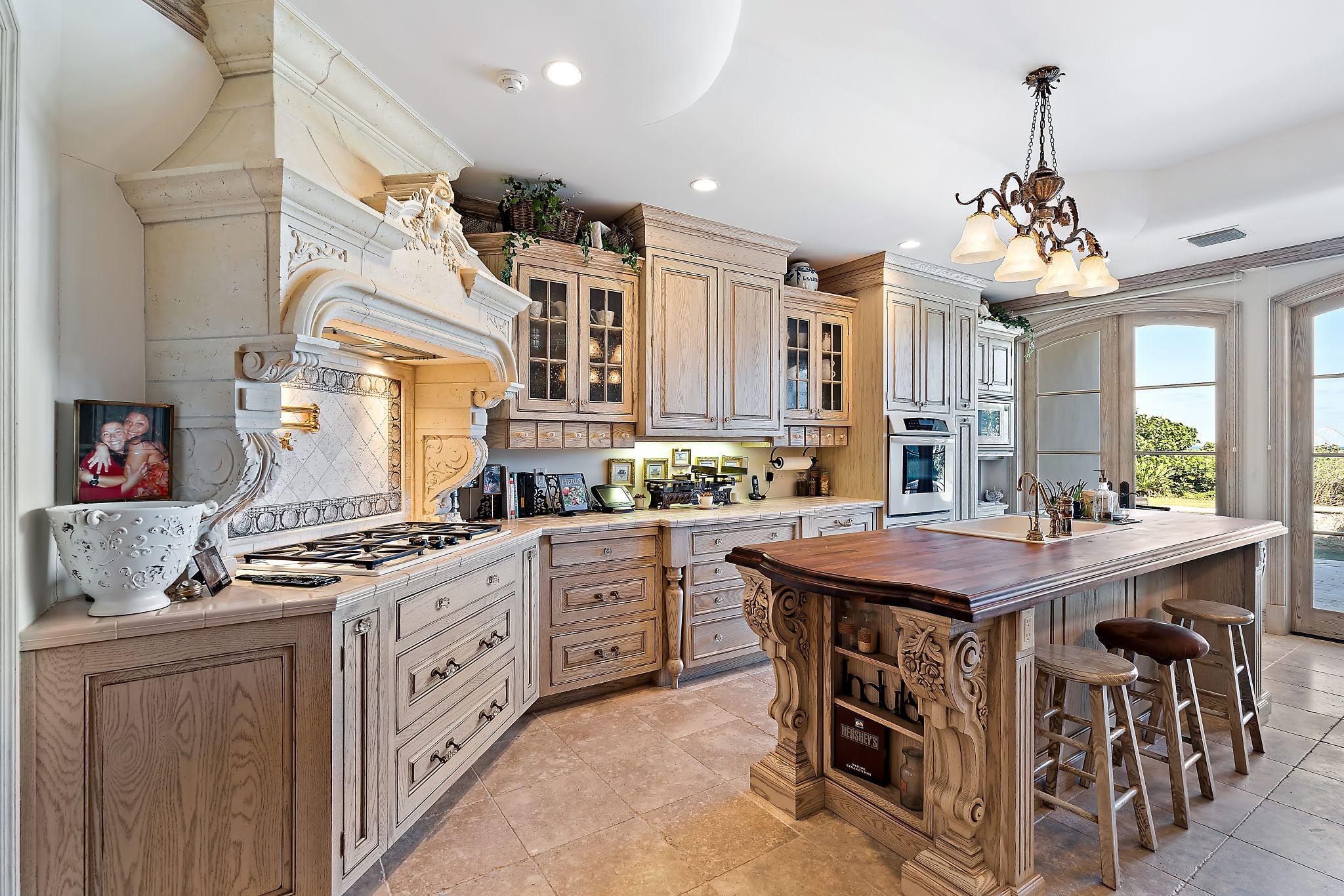 19 North Beach Road Hobe Sound, FL 33455 - Photo 16 of 75 Kitchen with gas range and double island