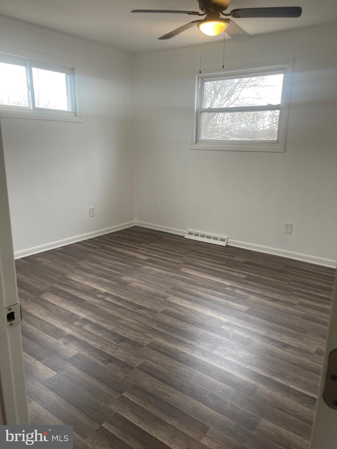 183 Lincoln Road Wenonah, NJ 08090 - Photo 13 of 19 an empty room with wooden floor and windows